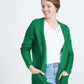 Woman wearing a green or coral waffle knit cardigan