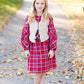 Young girl wearing a modest red plaid midi dress with balloon style sleeves. This dress also features a self tie fabric waist and is lined.