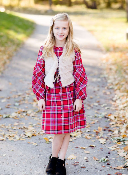 Young girl wearing a modest red plaid midi dress with balloon style sleeves. This dress also features a self tie fabric waist and is lined.