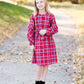 Young girl wearing a modest red plaid midi dress with balloon style sleeves. This dress also features a self tie fabric waist and is lined.