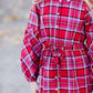 Young girl wearing a modest red plaid midi dress with balloon style sleeves. This dress also features a self tie fabric waist and is lined.