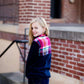 This half zip pullover features a front pouch pocket and a beautiful color block print of fuchsia, teal and mustard!  This young girl is also matching her mother in a mommy and me style.