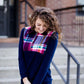 This half zip pullover features a front pouch pocket and a beautiful color block print of fuchsia, teal and mustard! It also is a mommy and me style.  