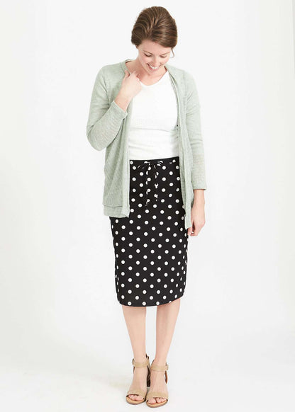 Woman wearing black and white stretch polka dot dress skirt