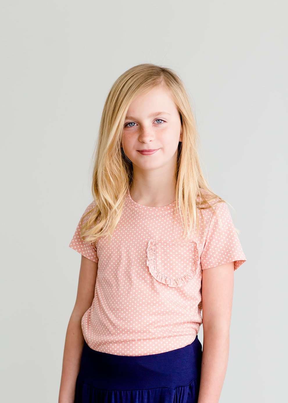 Girls modest blush polka dot tee with a ruffle front pocket