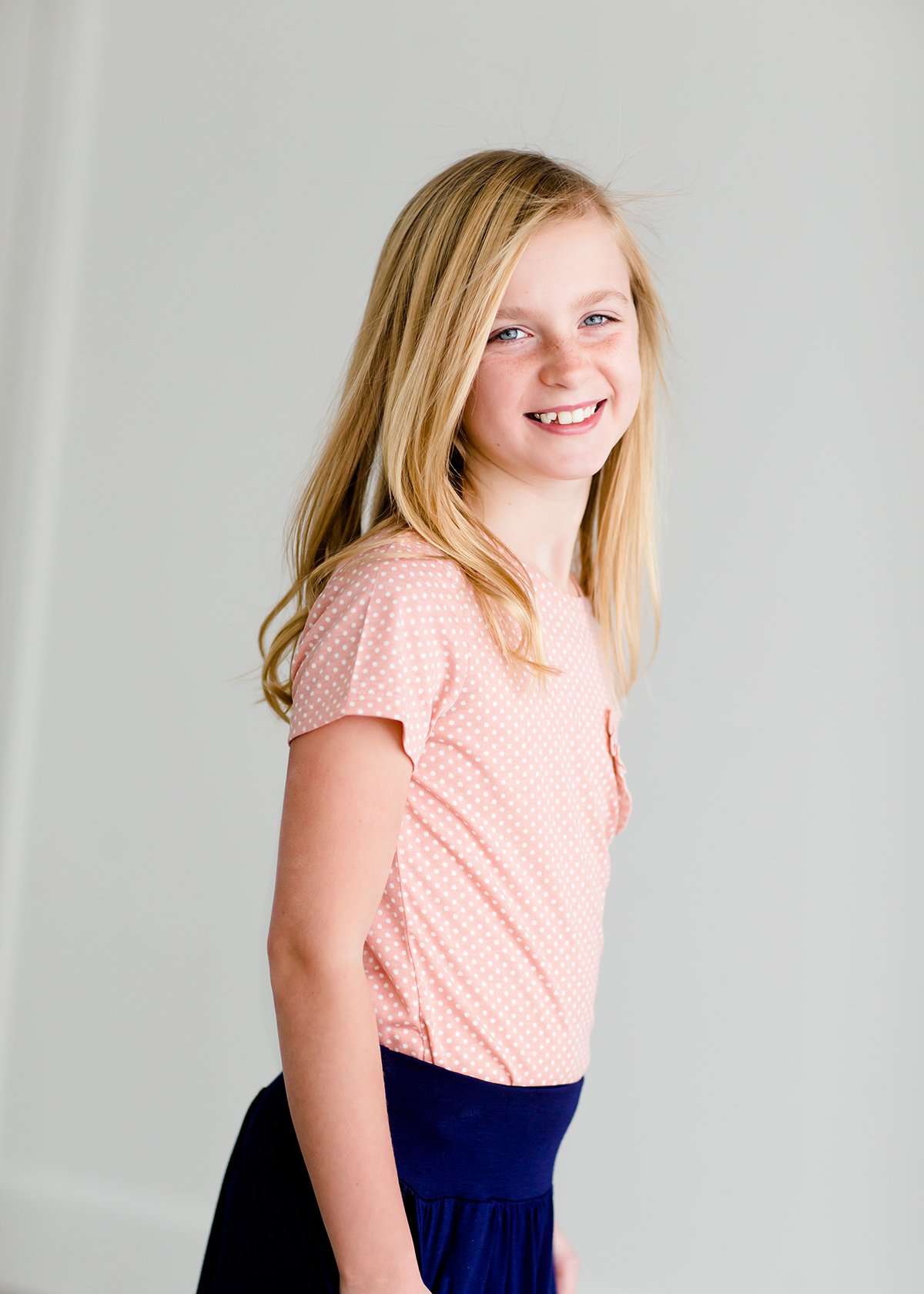 Girls modest blush polka dot tee with a ruffle front pocket