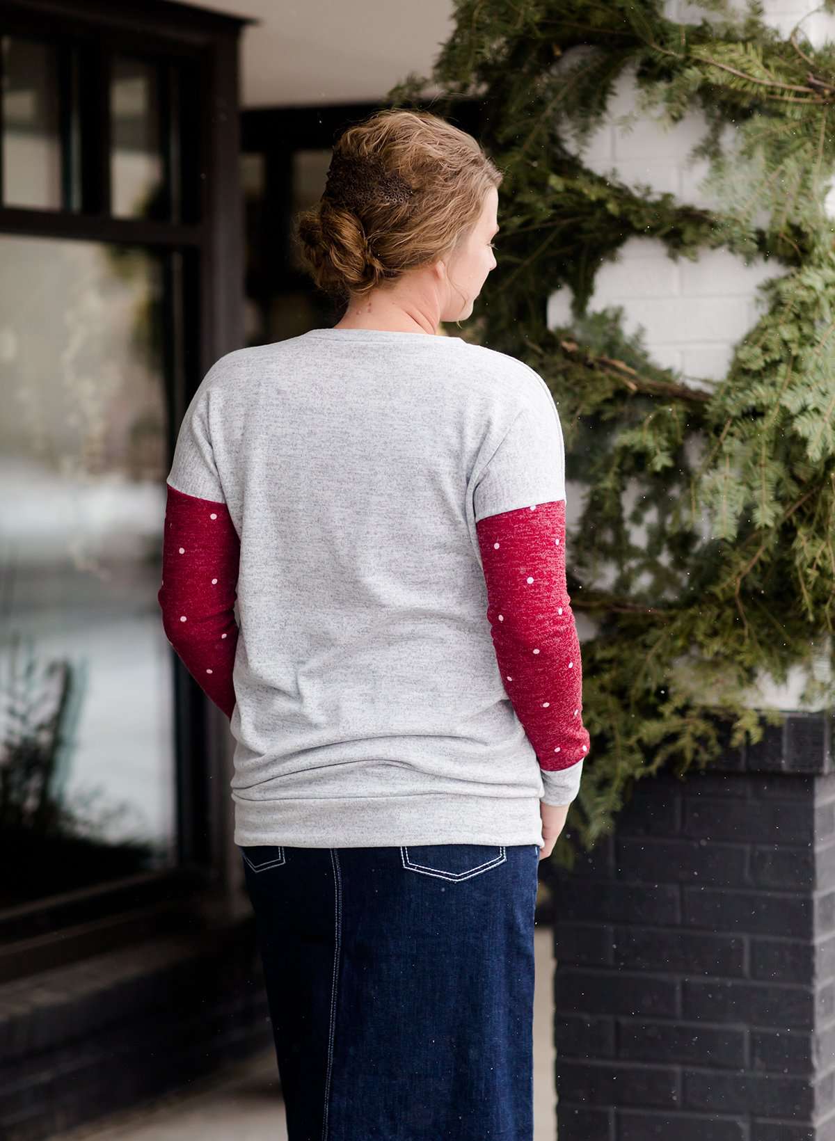 a gray and burgandy polka dot tunic style sweater with a front pocket