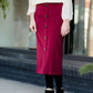 Modest below the knee wine colored skirt. This skirt has faux buttons and is paired with a white blouse and black boots.