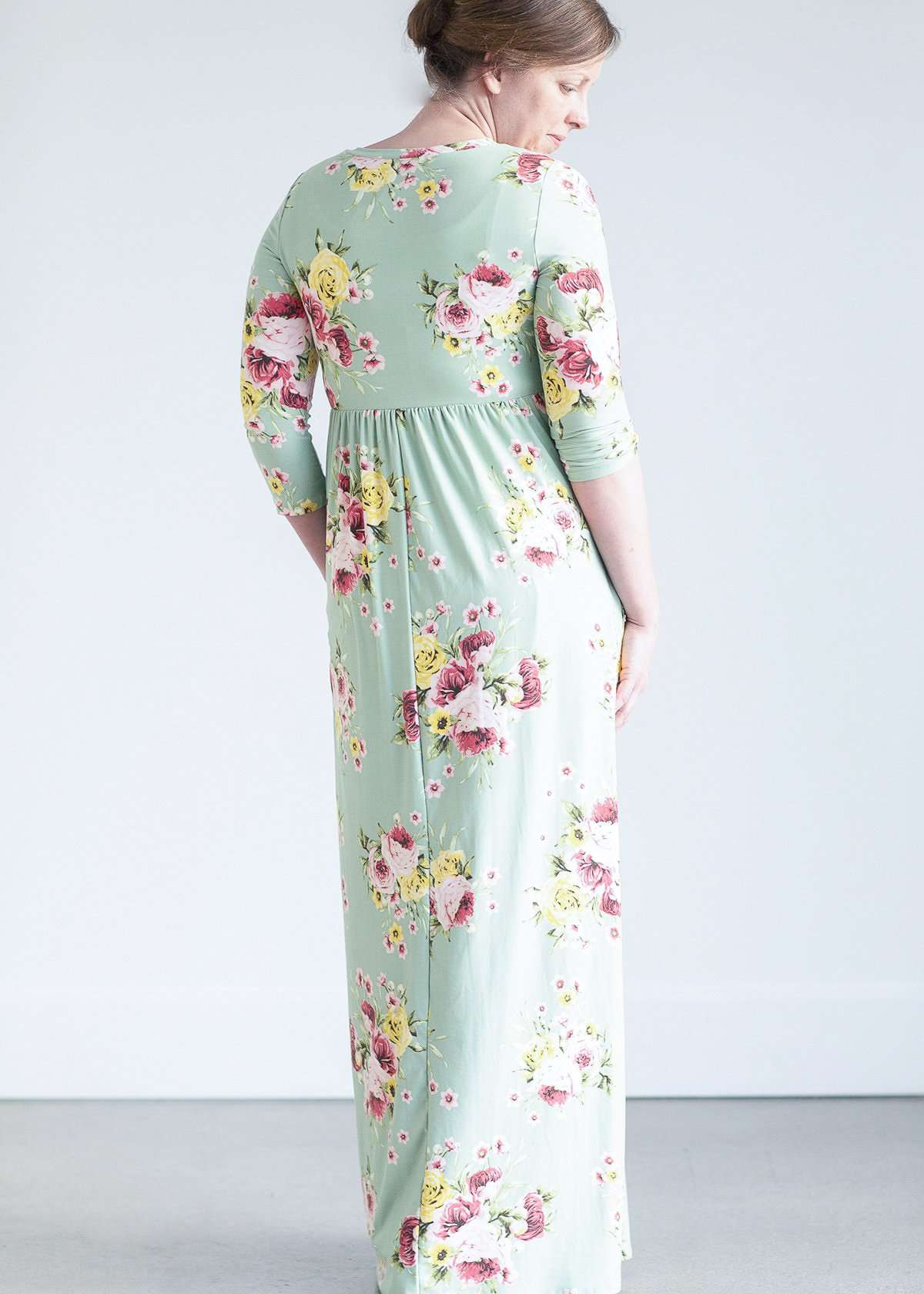 woman wearing a modest mint and floral maxi dress