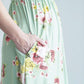 woman wearing a modest mint and floral maxi dress