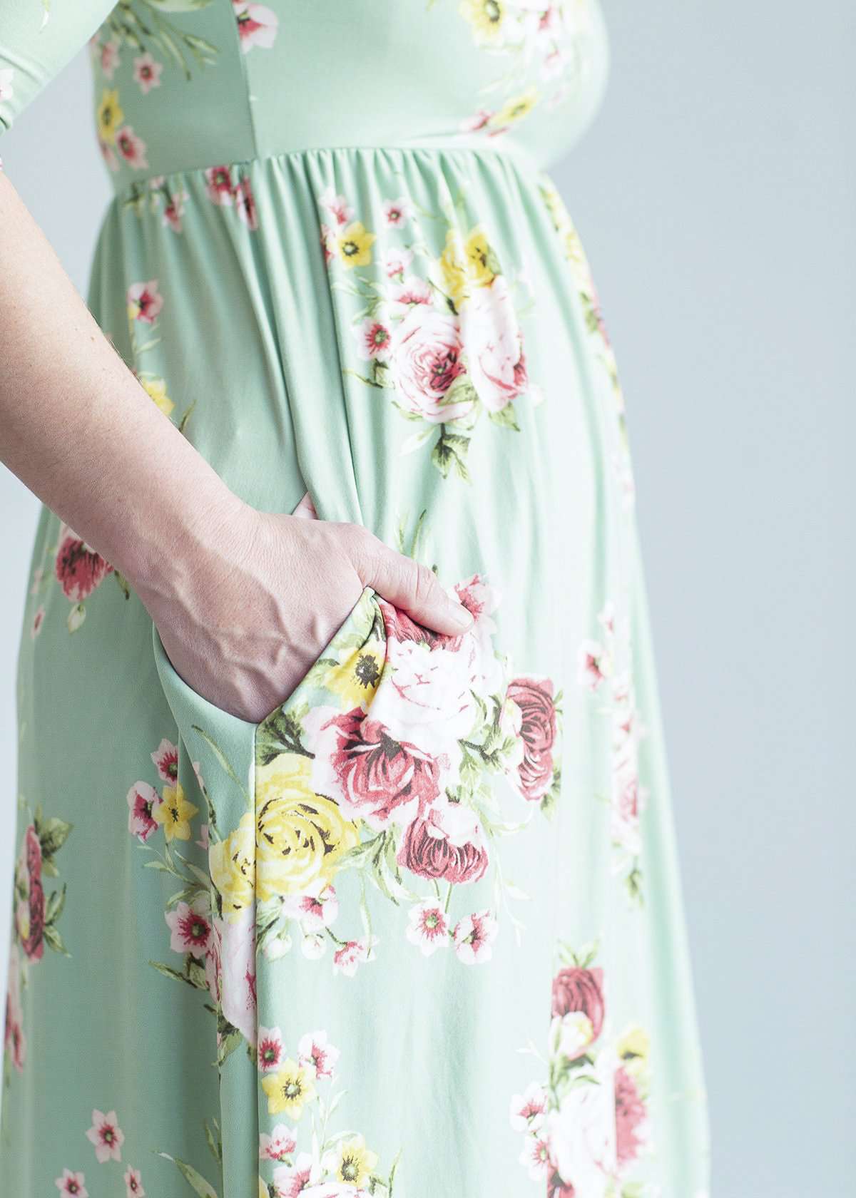woman wearing a modest mint and floral maxi dress