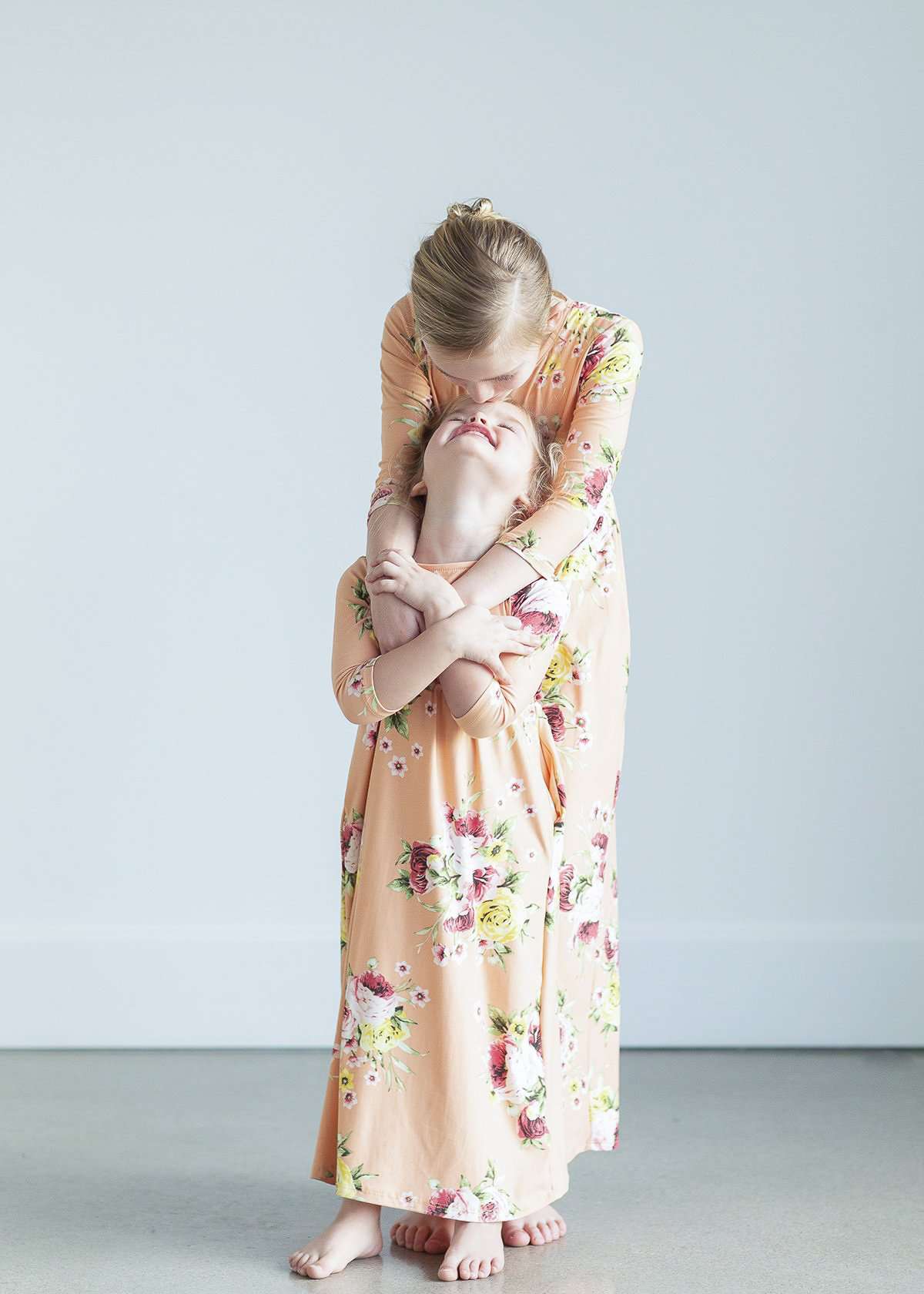 young girl wearing a modest mint and floral maxi dress