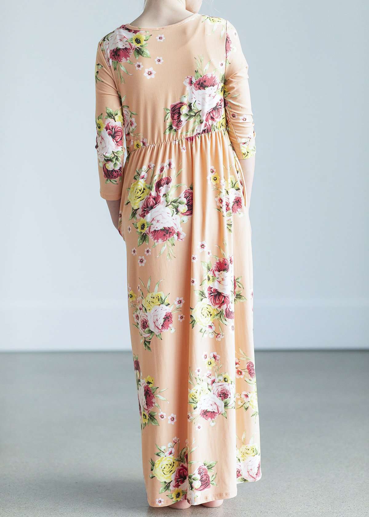 young girl wearing a modest mint and floral maxi dress