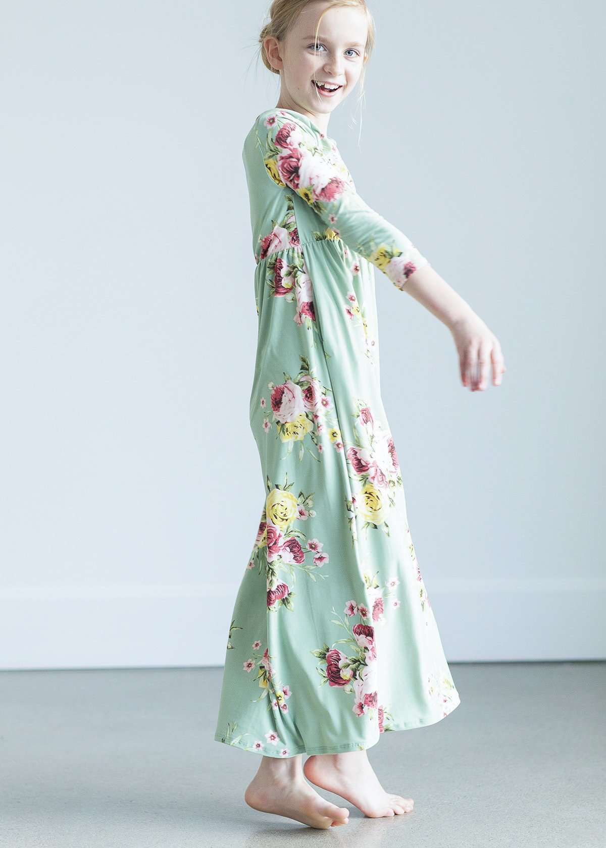young girl wearing a modest mint and floral maxi dress
