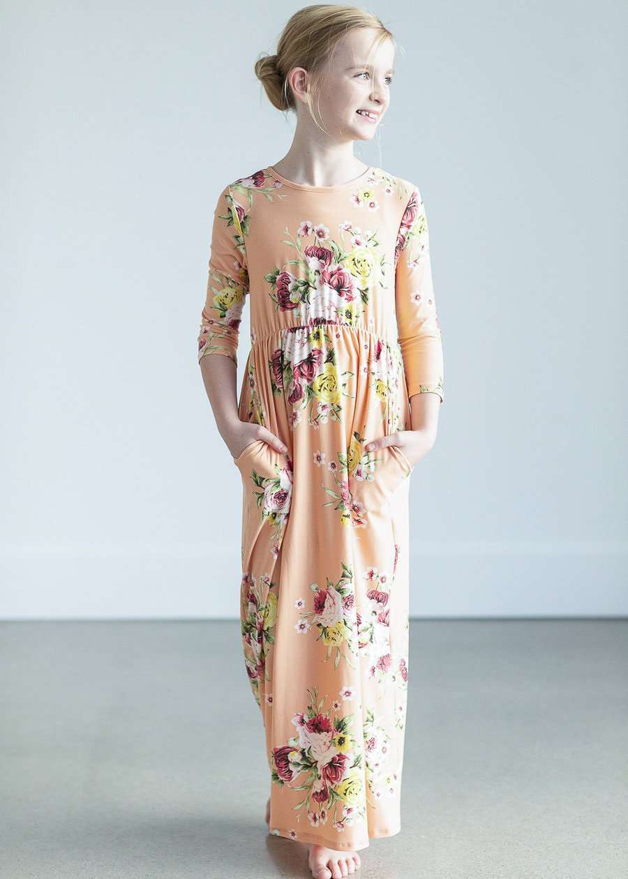 young girl wearing a modest mint and floral maxi dress