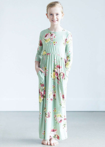 young girl wearing a modest mint and floral maxi dress