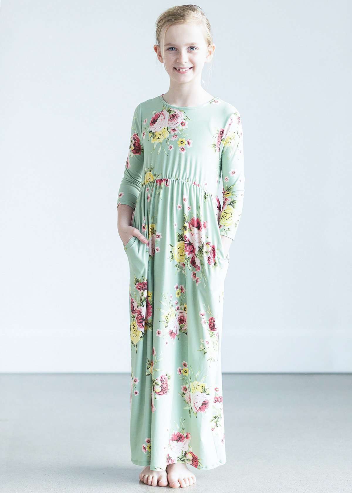 young girl wearing a modest mint and floral maxi dress