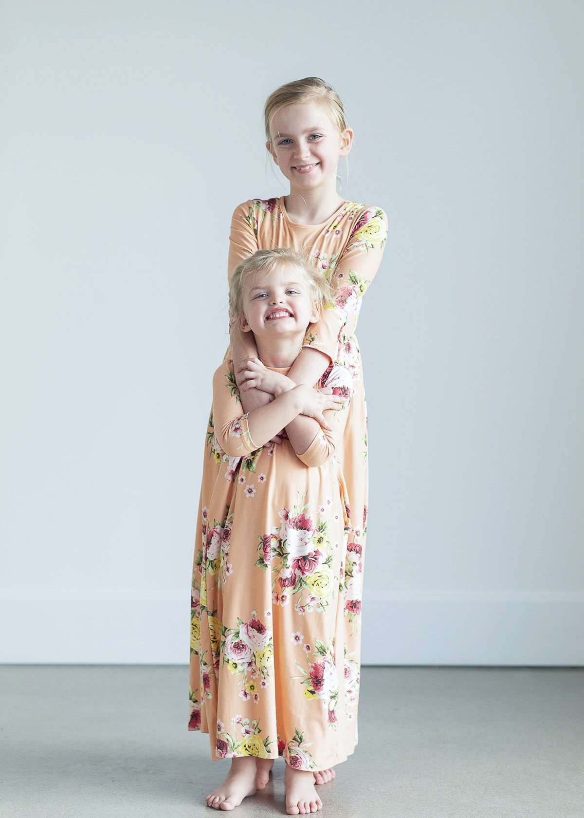 young girl wearing a modest mint and floral maxi dress