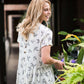 greenery patterned peplum white top with faux buttons on back