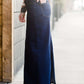 Woman wearing a long denim jean skirt that has a dark wash and a light wash. this is a long modest jean skirt.