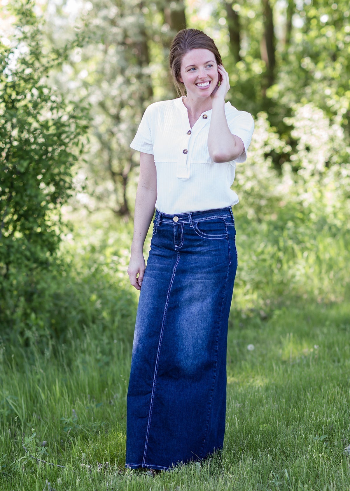 woman wearing a long dark denim jean skirt