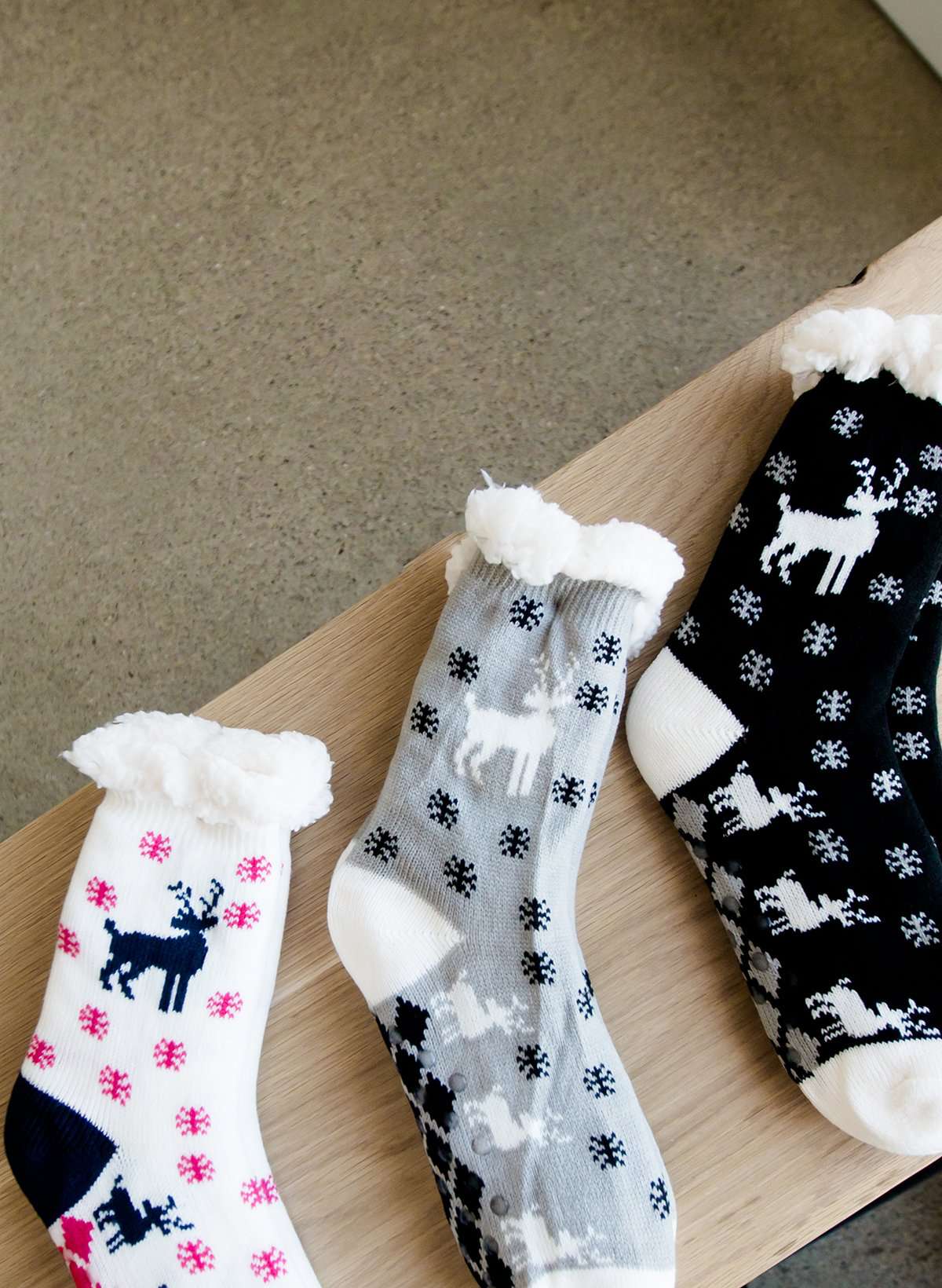 Reindeer Christmas scene slipper socks in gray, cream and black.