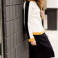 Woman wearing a black below the knee denim midi skirt.