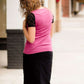 Woman wearing a black below the knee denim midi skirt.