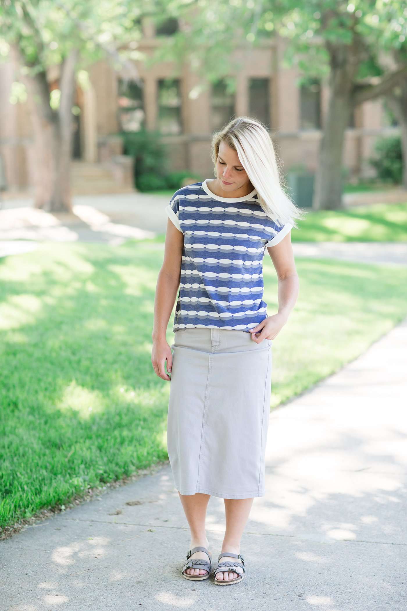 Woman wearing a gray below the knee skirt