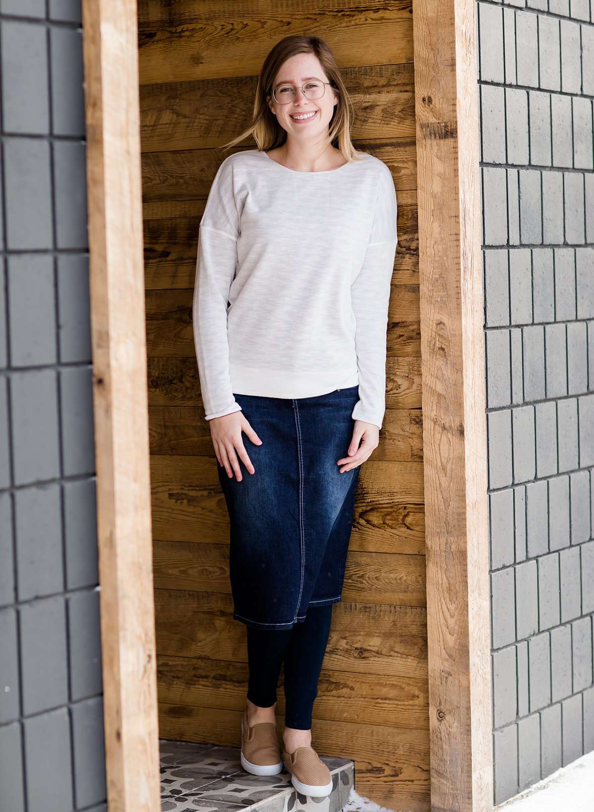 woman wearing a reversible knit top in purple and white 