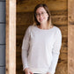 woman wearing a reversible knit top in purple and white 