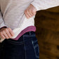 woman wearing a reversible knit top in purple and white 