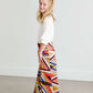 Girl wearing a modest maxi dress that is multi color and stretchy