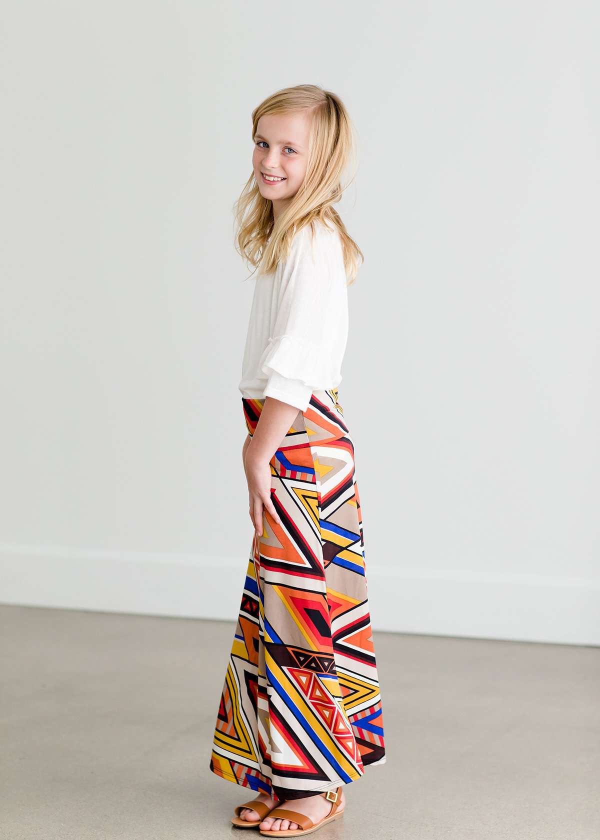 Girl wearing a modest maxi dress that is multi color and stretchy