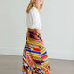 Girl wearing a modest maxi dress that is multi color and stretchy