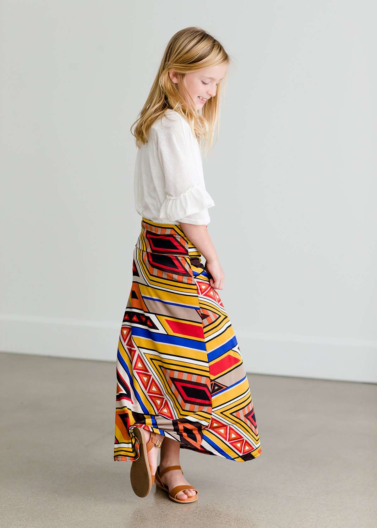 Girl wearing a modest maxi dress that is multi color and stretchy