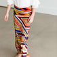 Girl wearing a modest maxi dress that is multi color and stretchy