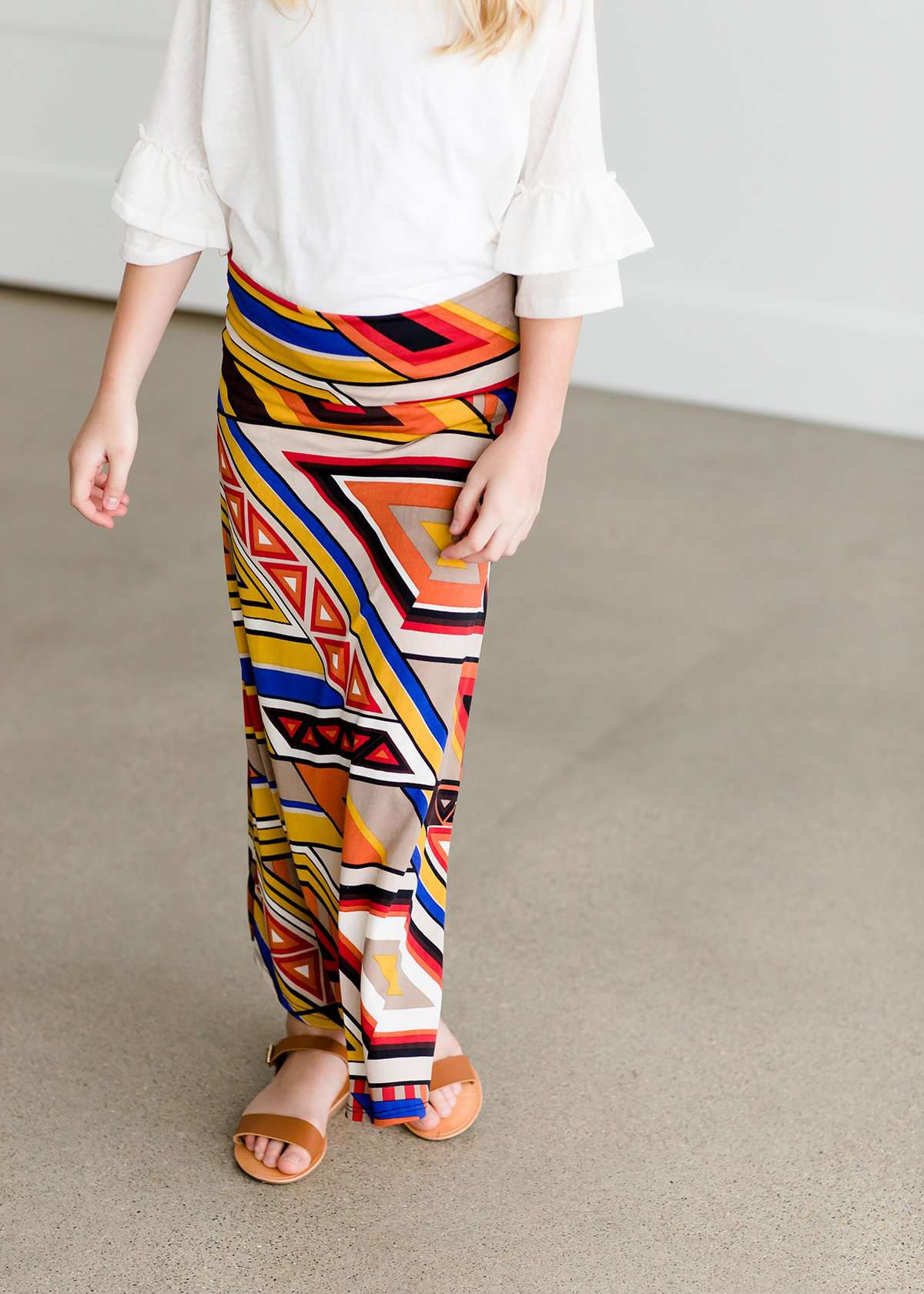 Girl wearing a modest maxi dress that is multi color and stretchy