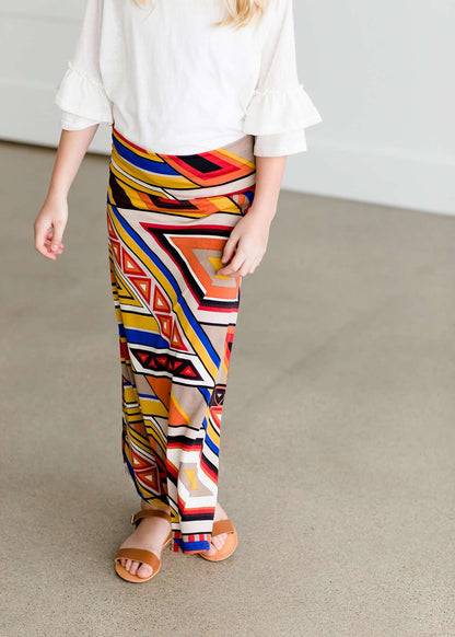 Girl wearing a modest maxi dress that is multi color and stretchy