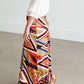 Girl wearing a modest maxi dress that is multi color and stretchy