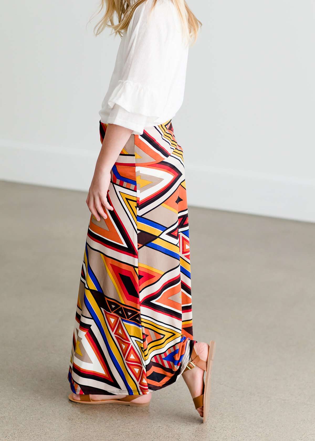 Girl wearing a modest maxi dress that is multi color and stretchy