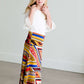 Girl wearing a modest maxi dress that is multi color and stretchy