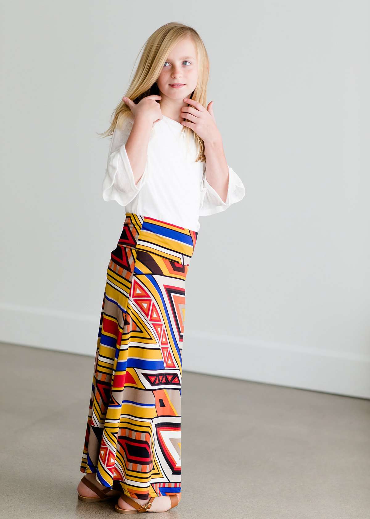 Girl wearing a modest maxi dress that is multi color and stretchy