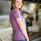 Mauve and Olive Minnesota screen printed tee shirt. These shirts are worn by a model standing in front of Inherit Clothing Company.