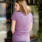 Mauve and Olive Minnesota screen printed tee shirt. These shirts are worn by a model standing in front of Inherit Clothing Company.