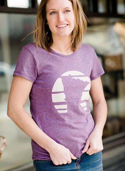 Mauve and Olive Minnesota screen printed tee shirt. These shirts are worn by a model standing in front of Inherit Clothing Company.