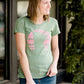 Mauve and Olive Minnesota screen printed tee shirt. These shirts are worn by a model standing in front of Inherit Clothing Company.