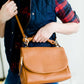 Sole Society Magnetic snap flap closure with zip around pocket, side snap gussets, exterior back zip pocket, detachable adjustable crossbody strap, dual interior compartments with center zip divider, back wall pocket with zipper closure crossbody purse