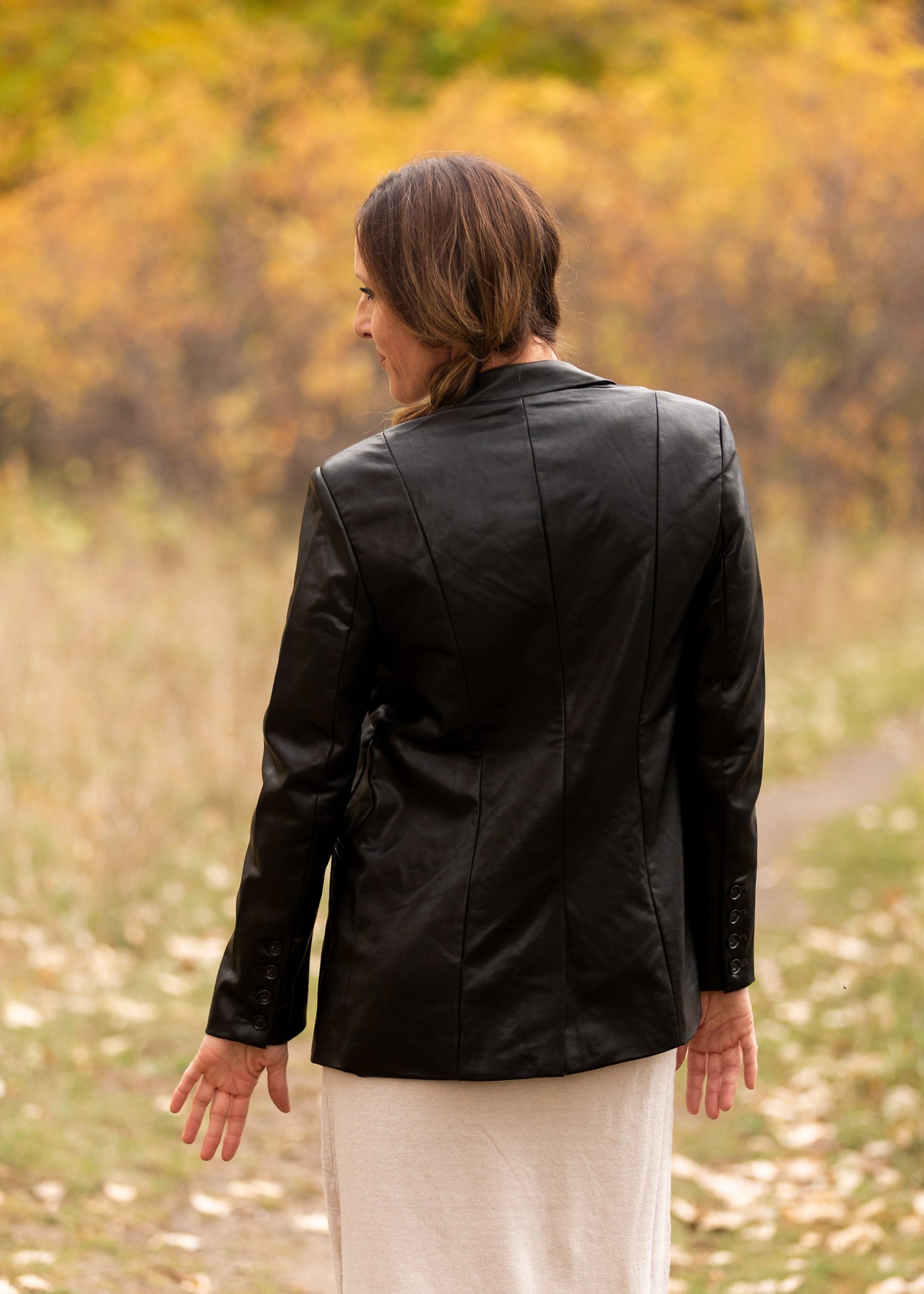 The Sandelle Faux Leather Blazer is a closet must-have! It is designed in a soft and supple vegan black leather fabric for elevated style. It has a one button closure in the center, a classic lapel collar, and it hits right below the hips for added modesty. There are functional front pockets at the waist to hold your essentials. The fit of this blazer is relaxed yet classy perfect over a dress or skirt and sweater! You will have so many outfit options with just this one layer! 