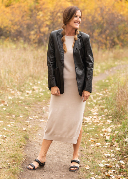 The Sandelle Faux Leather Blazer is a closet must-have! It is designed in a soft and supple vegan black leather fabric for elevated style. It has a one button closure in the center, a classic lapel collar, and it hits right below the hips for added modesty. There are functional front pockets at the waist to hold your essentials. The fit of this blazer is relaxed yet classy perfect over a dress or skirt and sweater! You will have so many outfit options with just this one layer! 